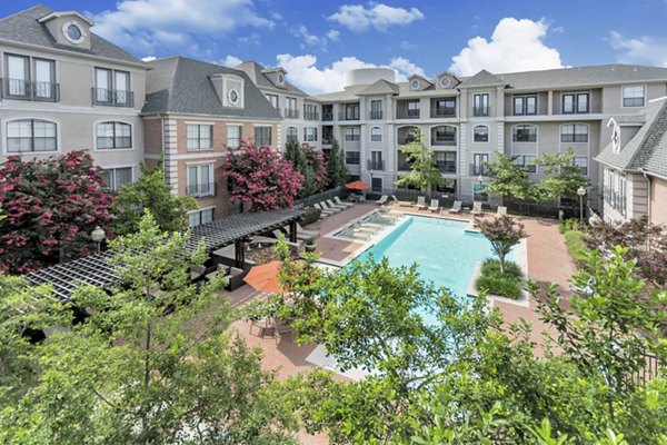 Elegant swimming pool at Renaissance at Preston Hollow Apartments with luxurious seating areas for ultimate relaxation