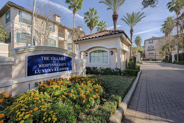 The Village at West University Apartments signage against modern architecture
