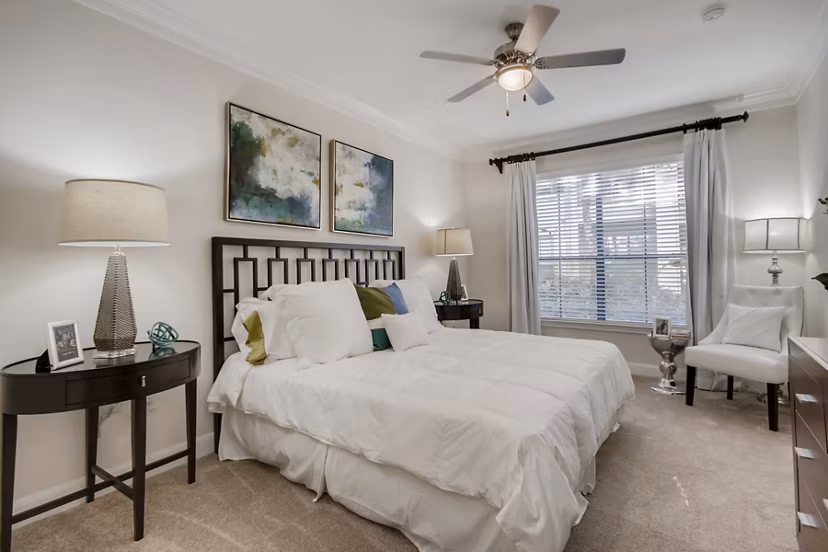 Cozy bedroom with stylish decor at The Village at West University Apartments