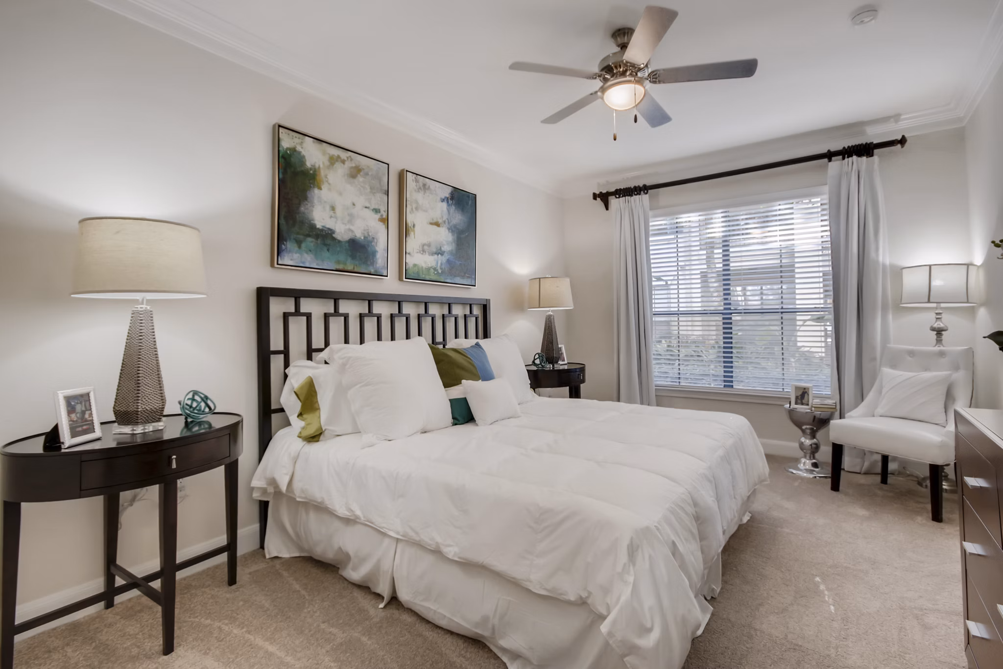 Cozy bedroom with stylish decor at The Village at West University Apartments