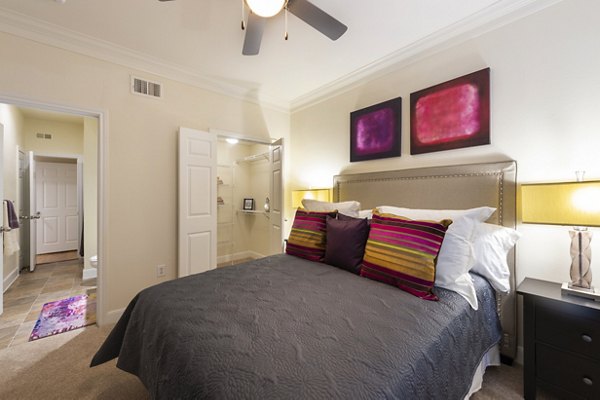 Cozy bedroom with modern furnishings at The Village at West University Apartments