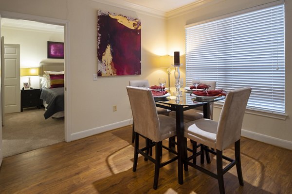 Dining area with modern furnishings at The Village at West University Apartments in Houston
