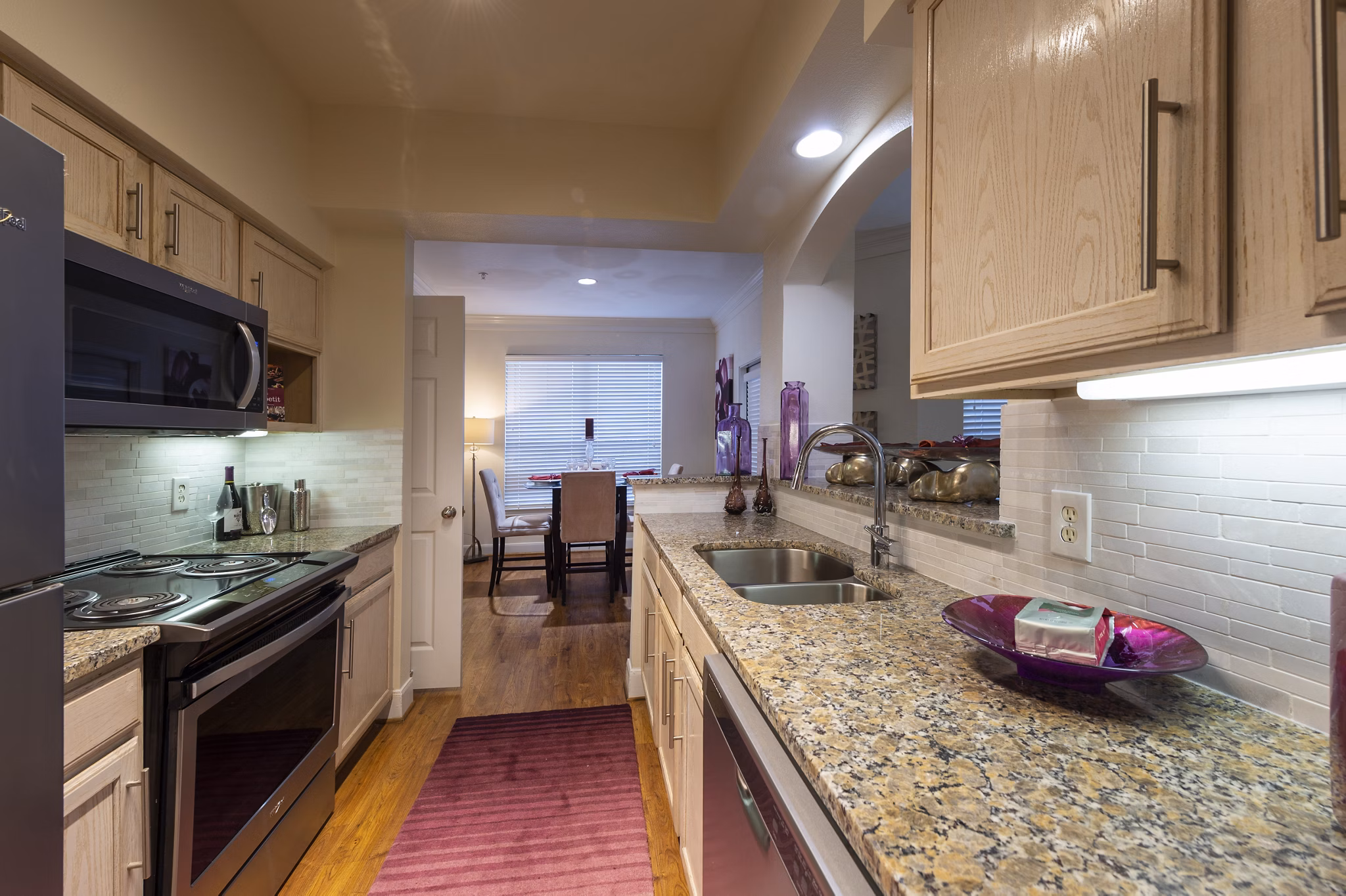 Modern kitchen with sleek stainless steel appliances at The Village at West University Apartments