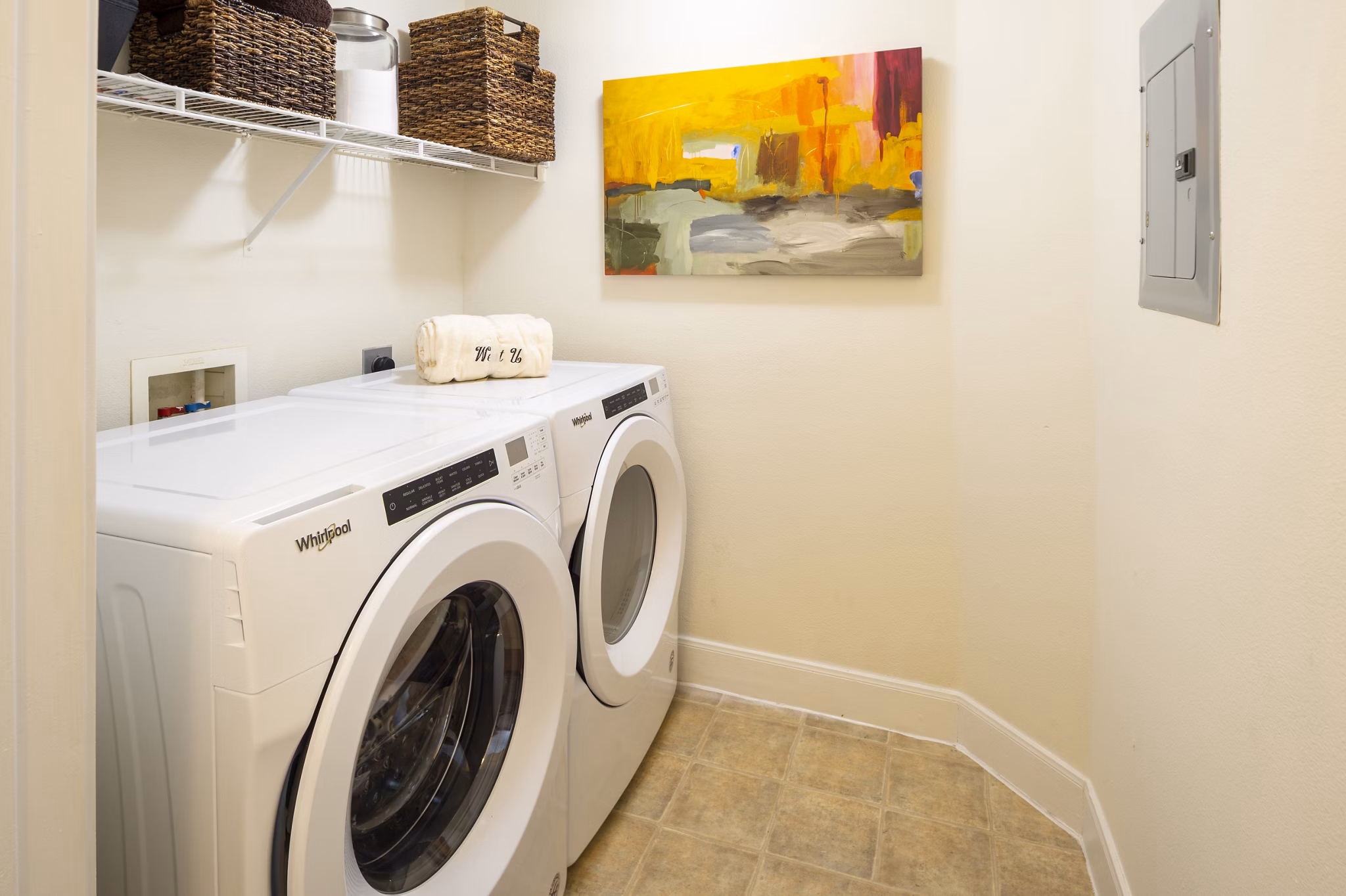 Laundry room with modern appliances at The Village at West University Apartments