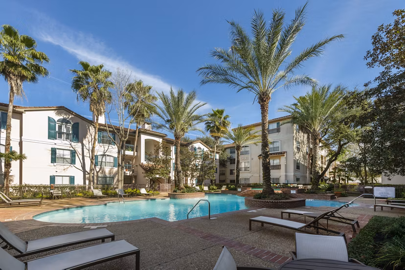 Luxurious pool at The Village at West University Apartments featuring modern design and comfortable lounge areas