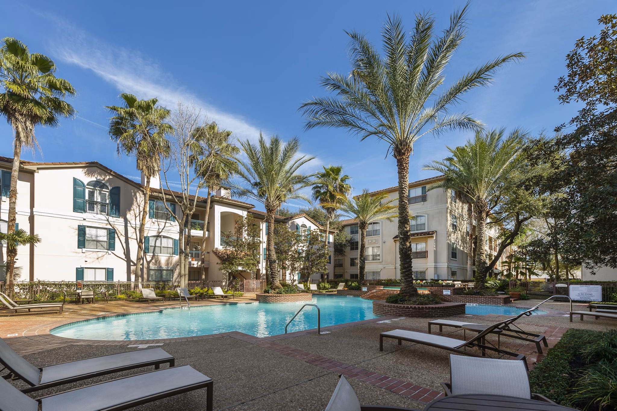 Luxurious pool at The Village at West University Apartments featuring modern design and comfortable lounge areas