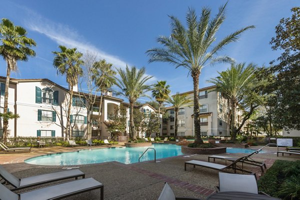 Luxurious pool at The Village at West University Apartments featuring modern design and comfortable lounge areas