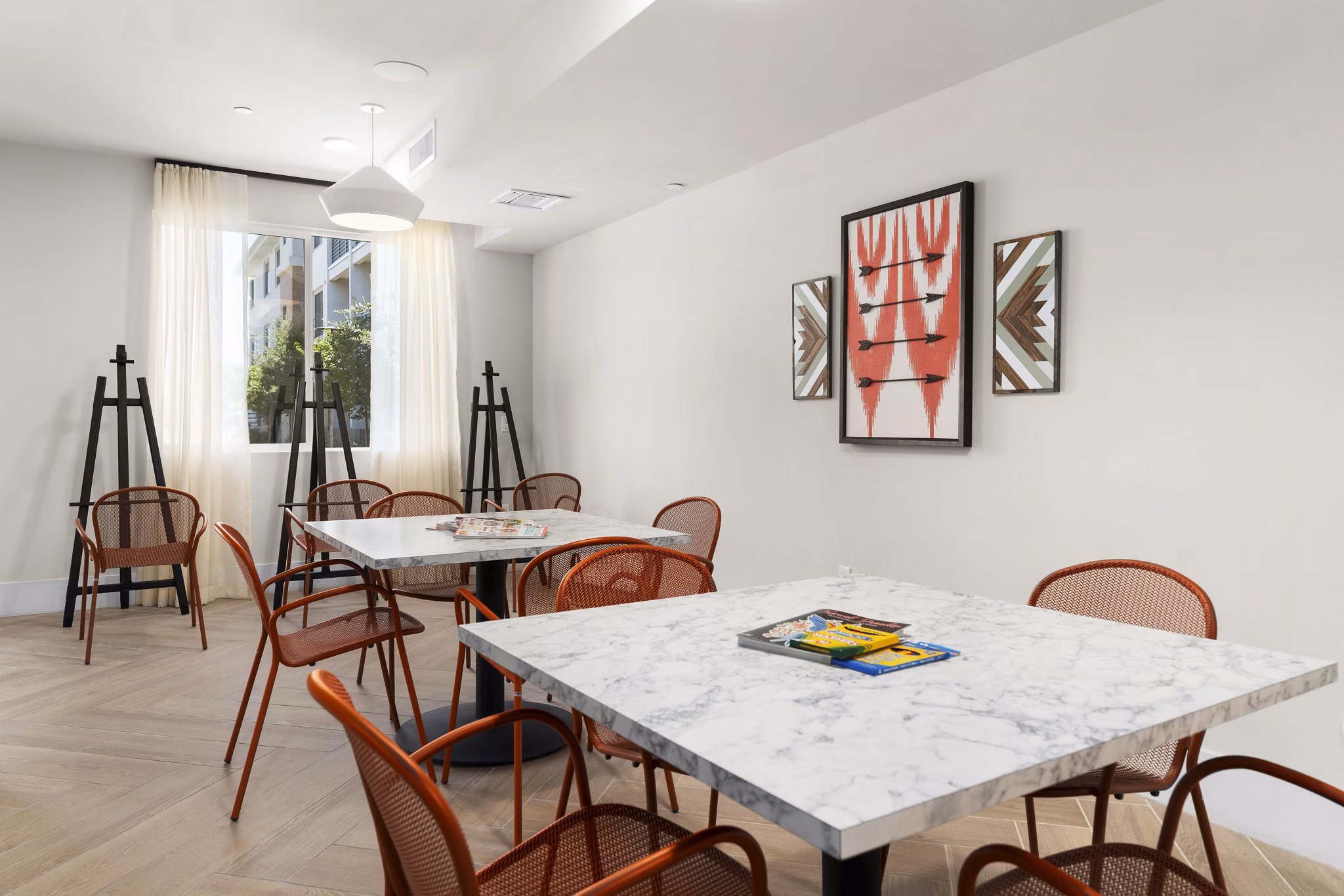 â€œElegant meeting room with tables, chairs, and artwork in luxury apartmentsâ€