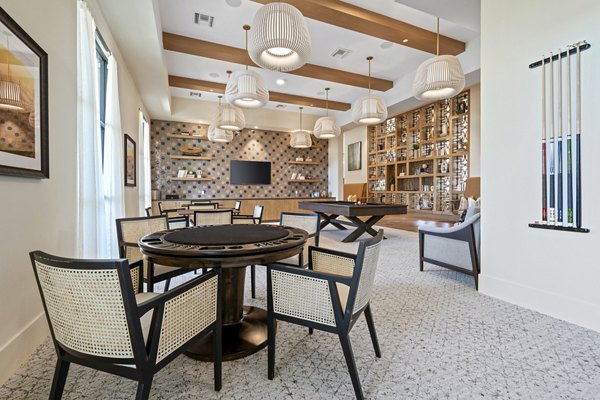 Clubhouse game room with pool table and lounge seating at Overture Arcadia Apartments