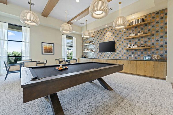 Clubhouse game room with billiards and lounge seating at Overture Arcadia Apartments