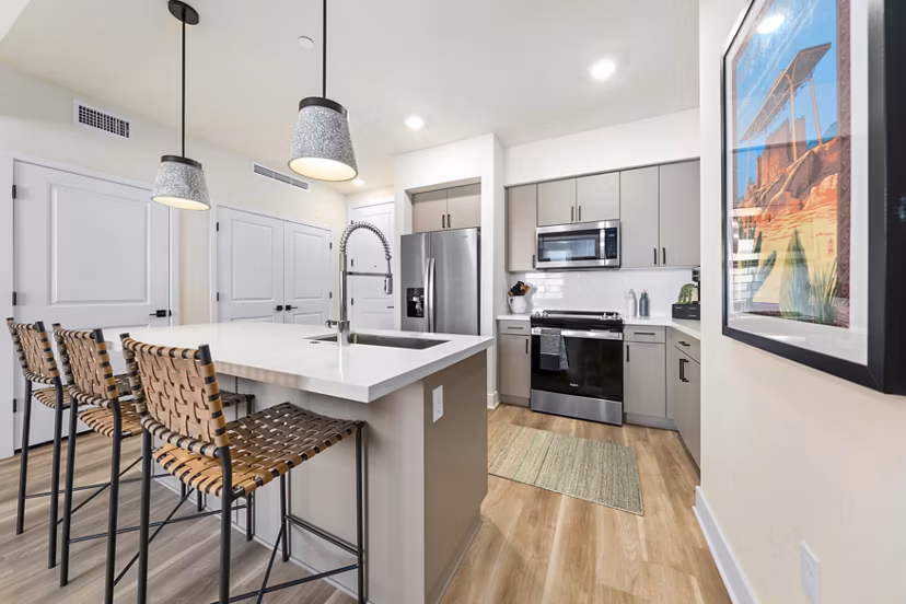Modern kitchen featuring stainless steel appliances and granite countertops at Overture Arcadia Apartments, luxurious living redefined