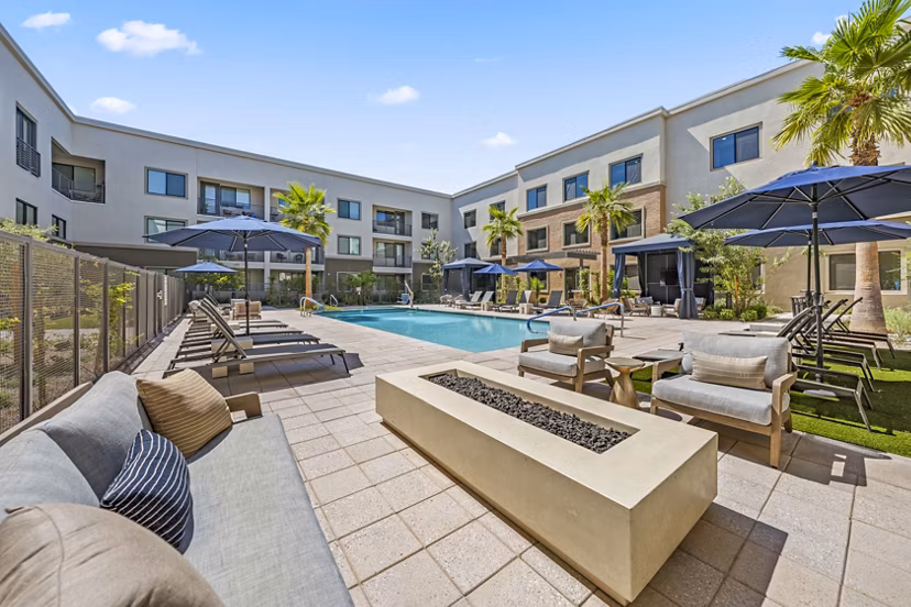 Chic outdoor pool at Overture Arcadia Apartments featuring lounge seating and lush landscaping, ideal for relaxation and leisure