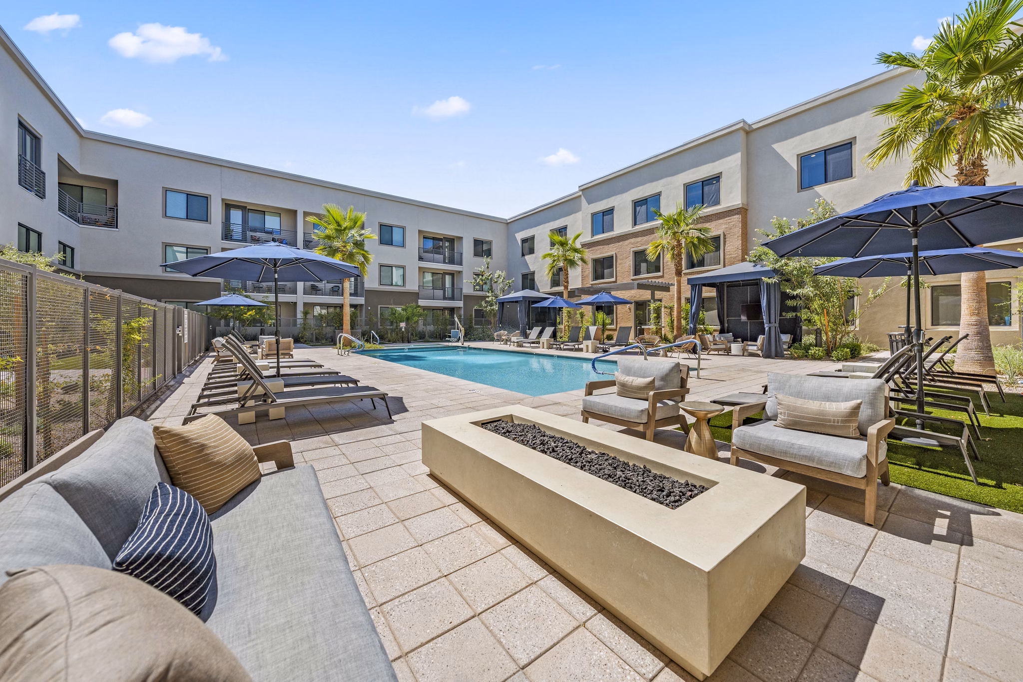 Chic outdoor pool at Overture Arcadia Apartments featuring lounge seating and lush landscaping, ideal for relaxation and leisure