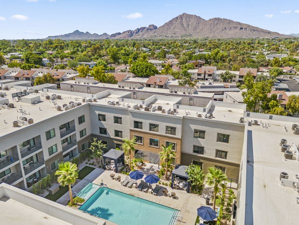 Inviting outdoor pool surrounded by loungers at Overture Arcadia Apartments, offering relaxation in a serene environment
