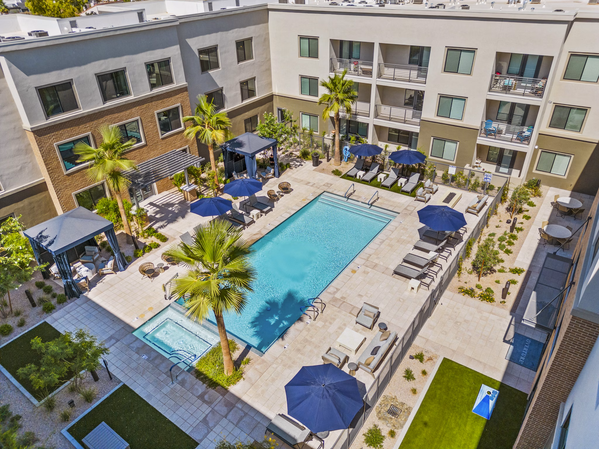 Outdoor pool surrounded by elegant loungers at Overture Arcadia Apartments, a luxury senior living community offering relaxation and recreation