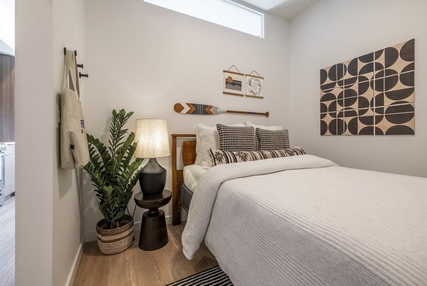 Cozy bedroom featuring neutral tones and modern design at Ballard Yards Apartments