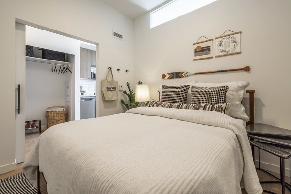 Cozy bedroom with modern furnishings at Ballard Yards Apartments