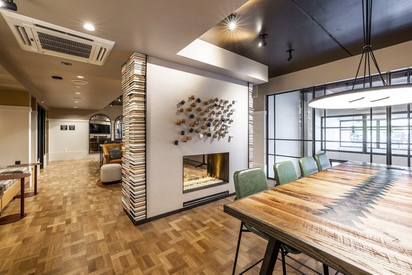 Stylish clubhouse with modern seating and pool table at Ballard Yards Apartments