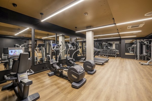 State-of-the-art fitness center at Ballard Yards Apartments offering modern equipment and well-lit workout spaces for residents