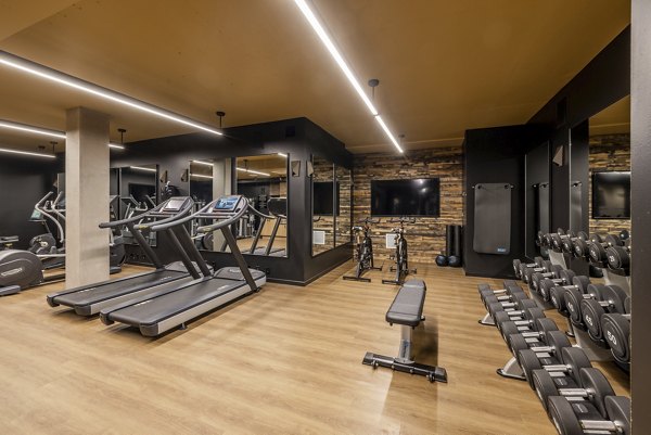 State-of-the-art fitness center with free weights and cardio machines at Ballard Yards Apartments