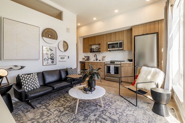 Cozy living room with chic decor and natural lighting in Ballard Yards Apartments