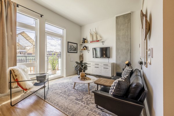 Spacious living room with modern decor and natural light in Ballard Yards Apartments