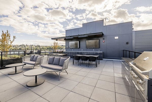 Outdoor grilling area at Ballard Yards Apartments with modern barbeque facilities and seating spaces