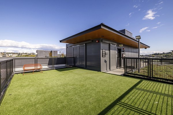 Off-leash dog park with agility equipment at Ballard Yards Apartments, a luxury community perfect for pet-friendly living