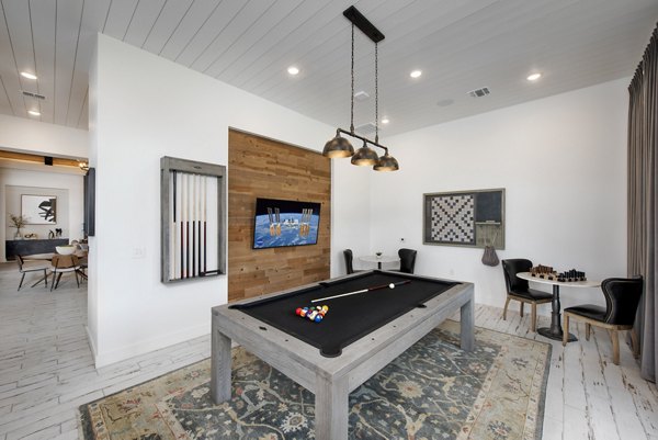 Clubhouse game room with billiards and lounge at Henry House at Clift Farm Apartments, Greystar luxury apartments