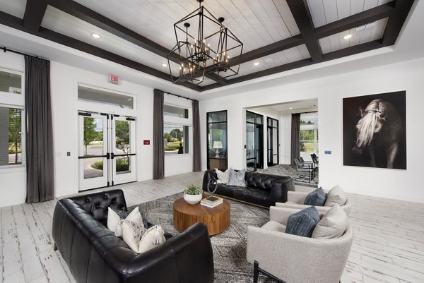 Clubhouse with modern seating and open layout at Henry House at Clift Farm Apartments, featuring luxury amenities and stylish design