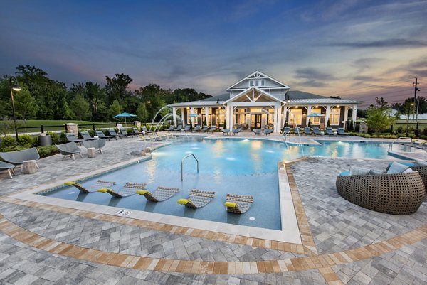 Resort-style pool with lounging areas at Henry House at Clift Farm Apartments