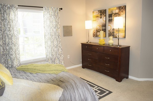 Bedroom with contemporary decor and cozy seating area at Park Crossing Apartments