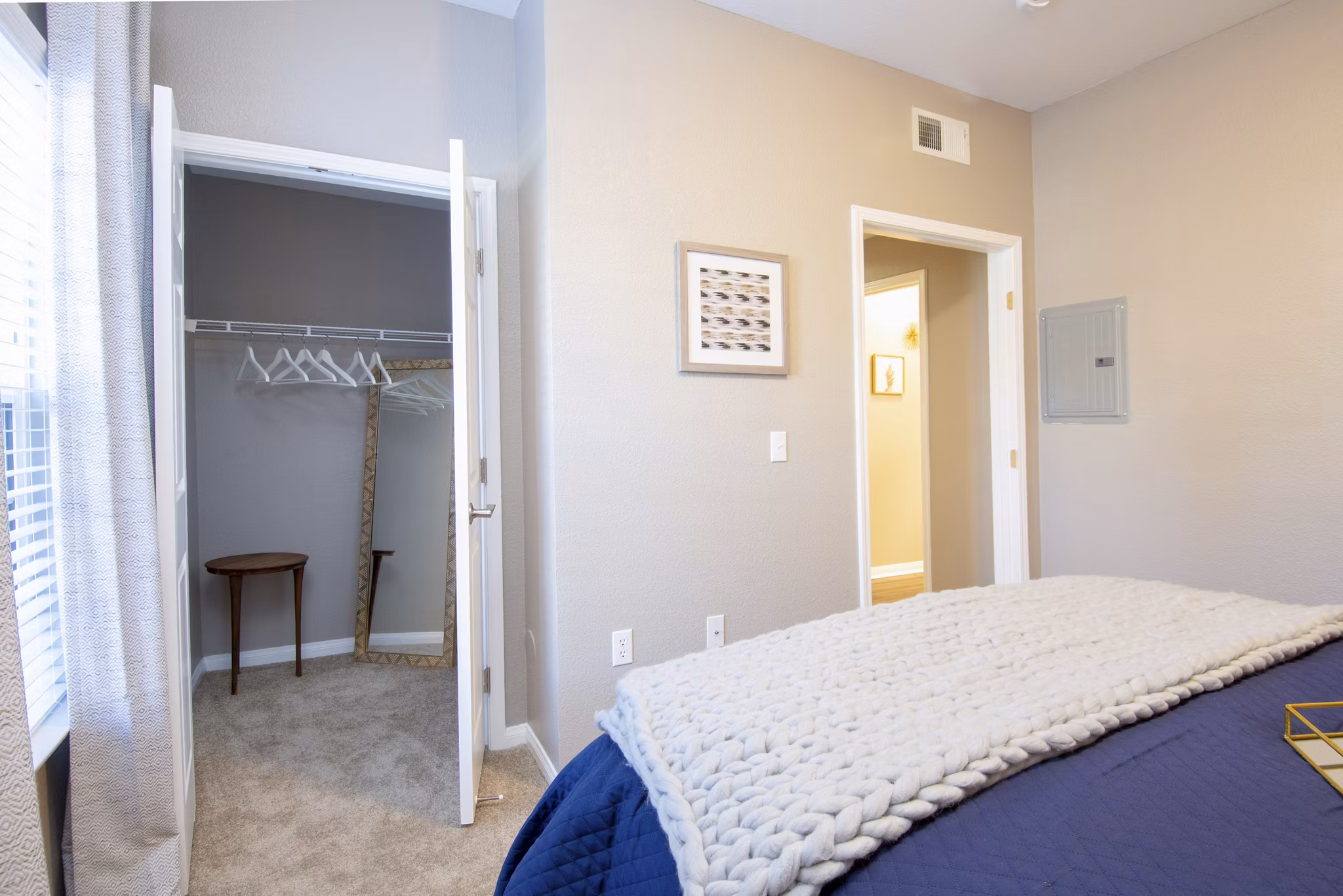 Cozy bedroom with modern decor and large windows at Park Crossing Apartments