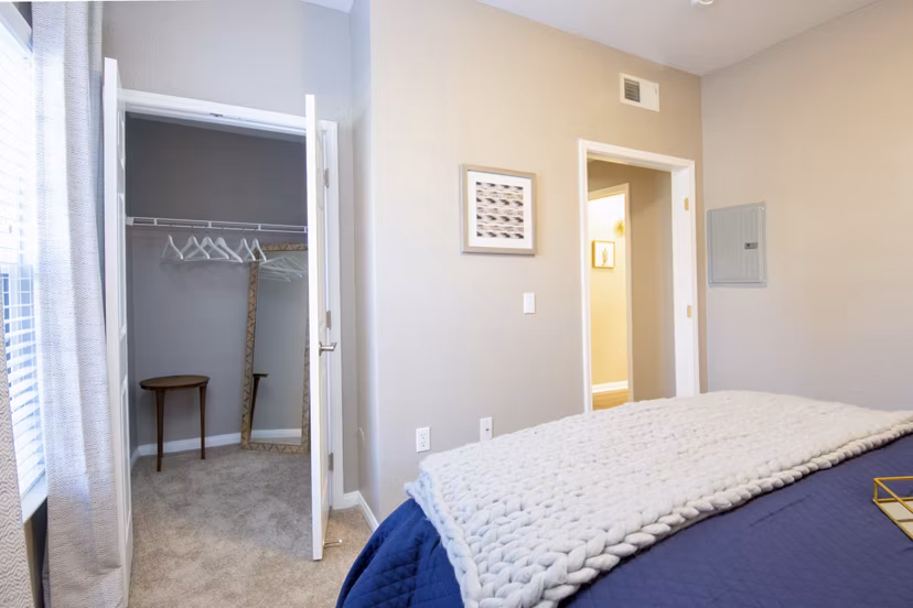 Cozy bedroom with modern decor and large windows at Park Crossing Apartments