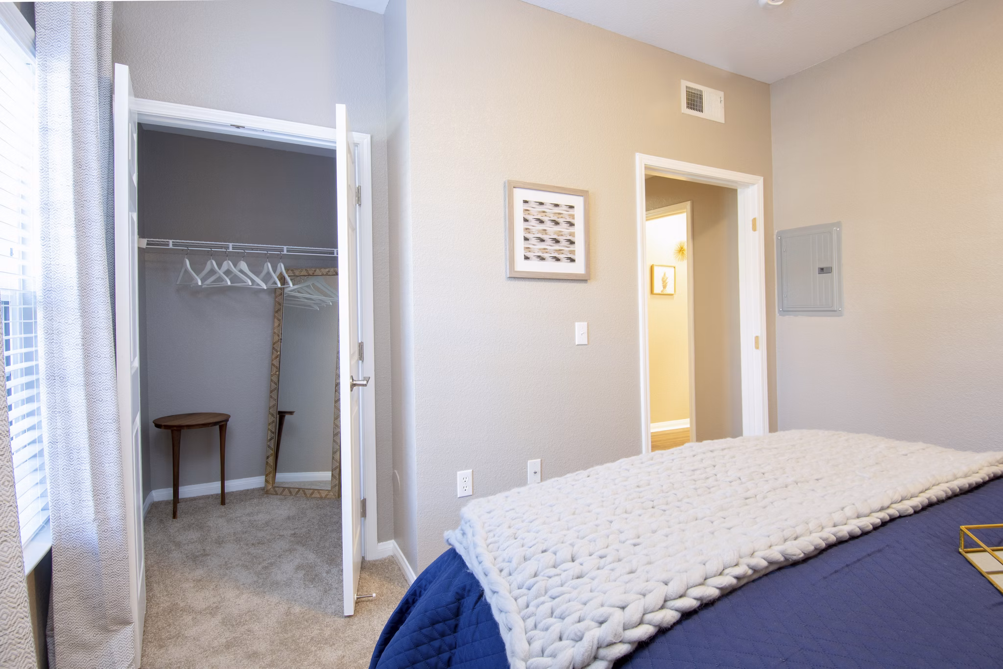 Cozy bedroom with modern decor and large windows at Park Crossing Apartments