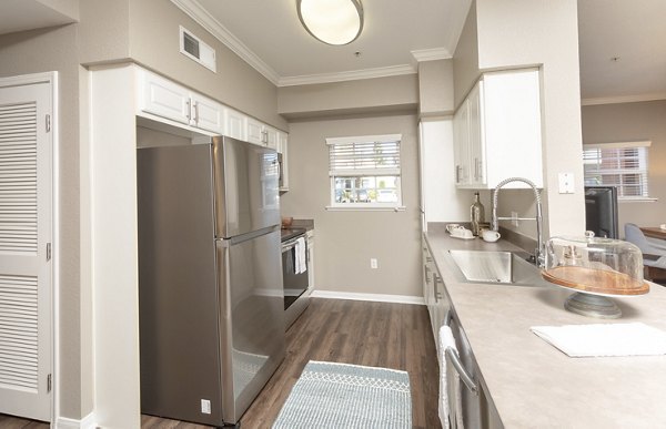 Modern kitchen with stainless steel appliances and granite countertops at Park Crossing Apartments