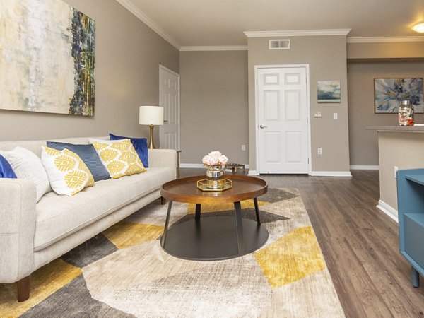 Spacious living room with modern furniture and large windows in Park Crossing Apartments