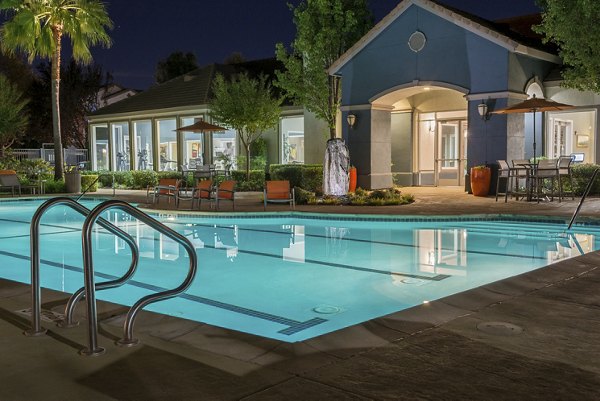 Modern outdoor pool at Park Crossing Apartments featuring lounge chairs and landscaped surroundings