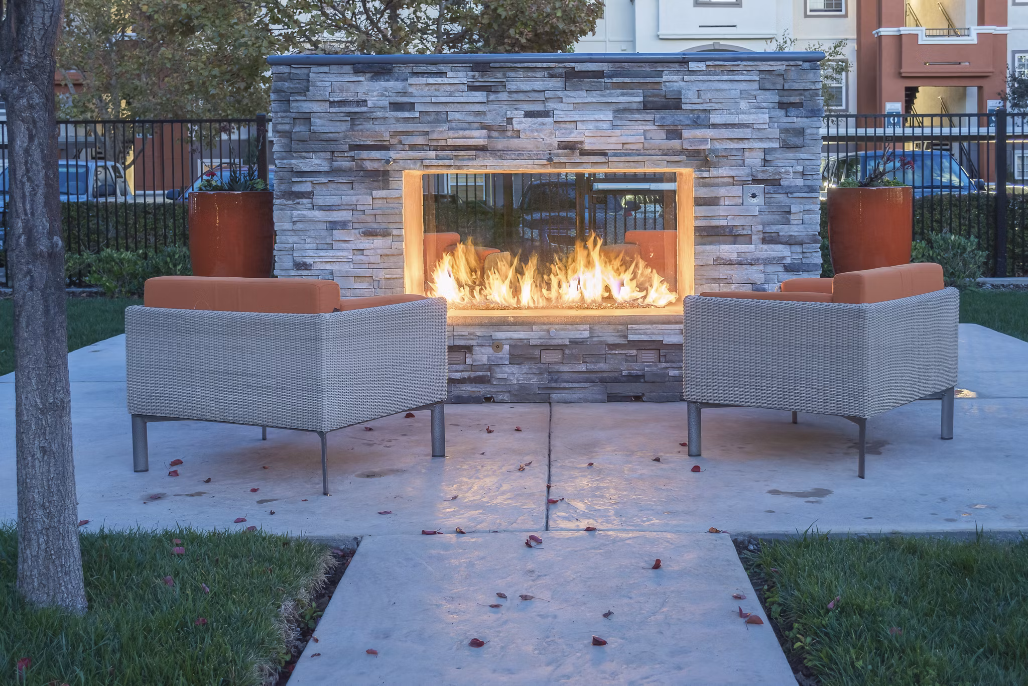Outdoor fire pit surrounded by cozy seating at Park Crossing Apartments, a luxury Greystar community