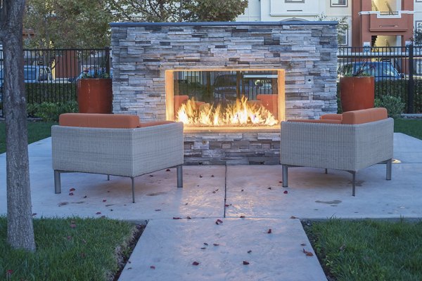 Outdoor fire pit surrounded by cozy seating at Park Crossing Apartments, a luxury Greystar community