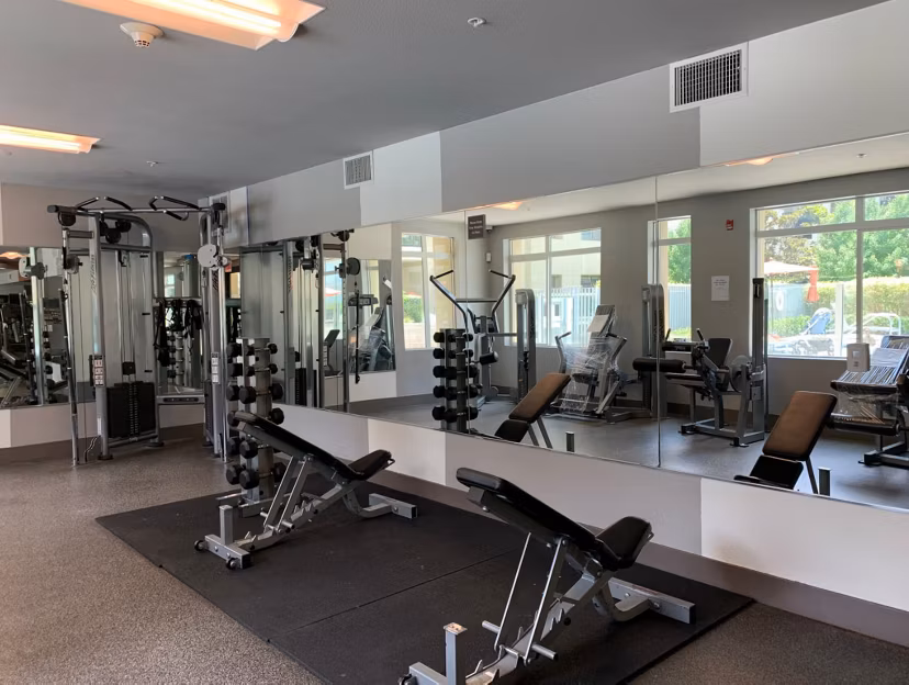 Fitness center at Westgate Apartments with modern equipment and spacious workout areas, ideal for active living