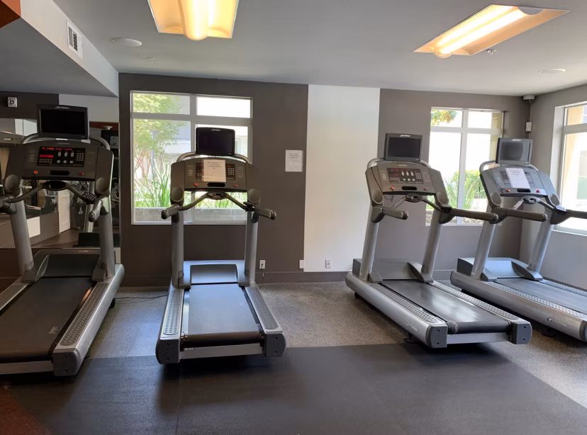 Modern fitness center featuring advanced equipment at Westgate Apartments