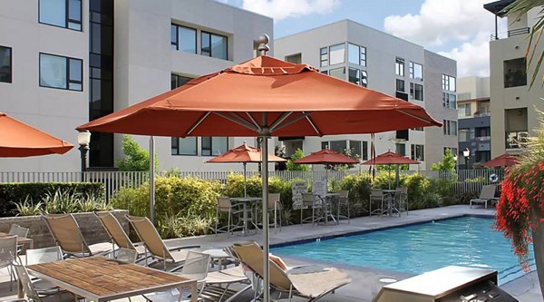 Relaxing pool area at Westgate Apartments with modern lounge chairs and scenic views