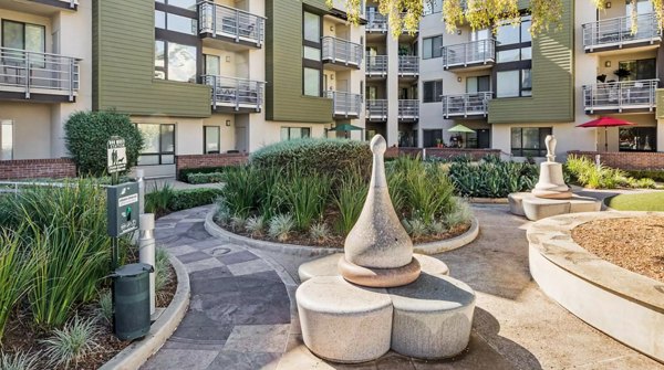 Lush courtyard with seating and greenery at Westgate Apartments luxury complex