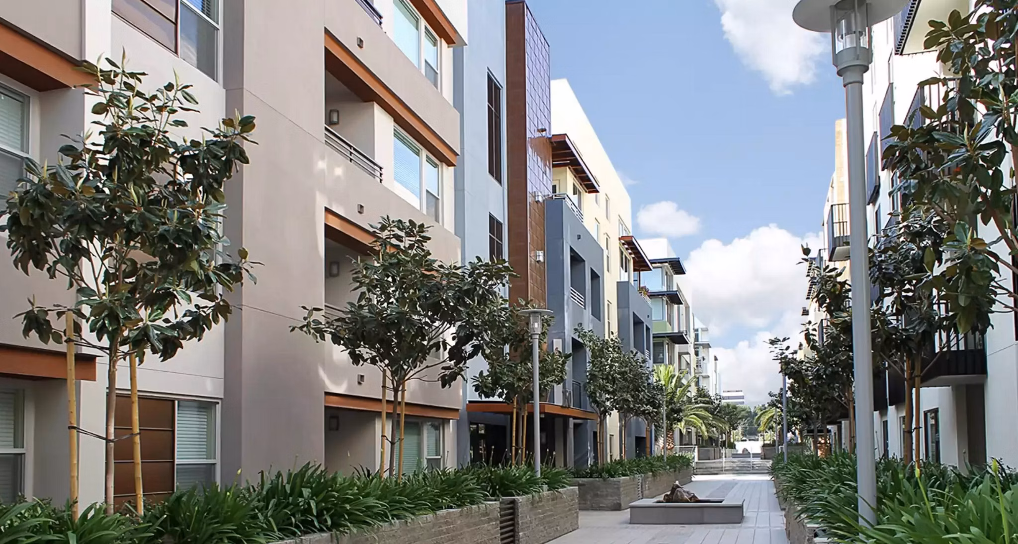 Courtyard featuring lush gardens and seating areas at Westgate Apartments