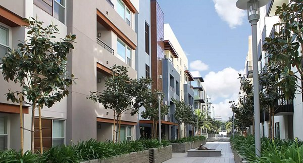 Courtyard featuring lush gardens and seating areas at Westgate Apartments