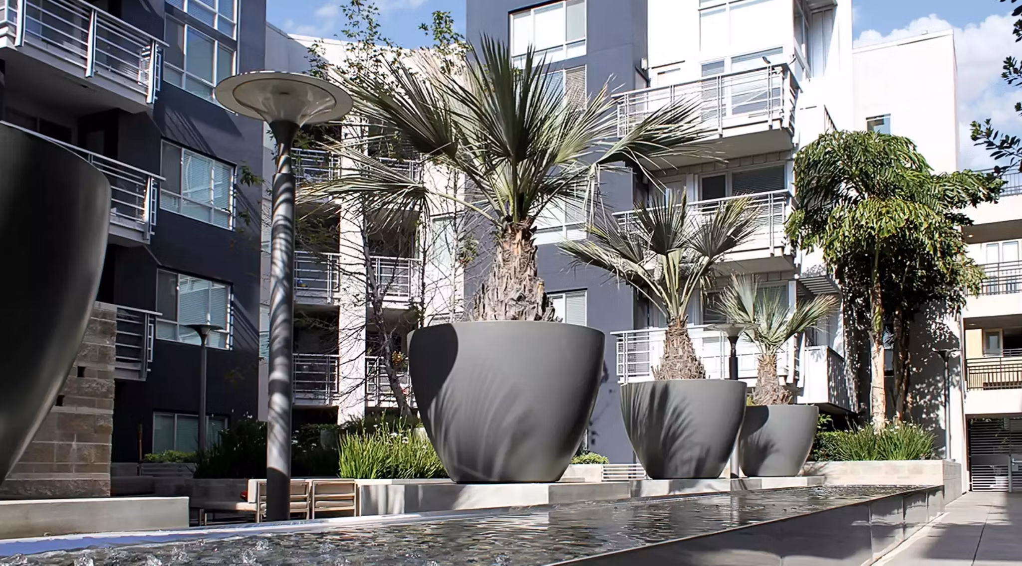 Courtyard with lush landscaping at Westgate Apartments, a luxury property featuring modern amenities and comfortable living spaces