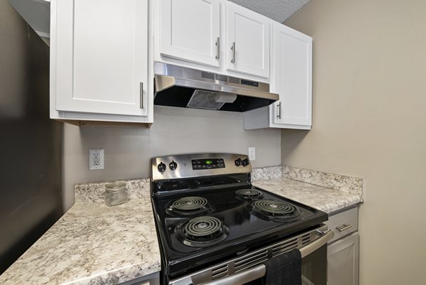 Modern kitchen with stainless steel appliances and granite countertops at Concord Apartments' luxury residences