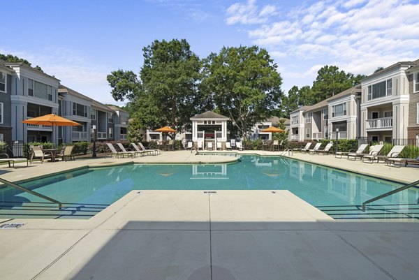 Luxurious outdoor pool with lounge chairs at Concord Apartments