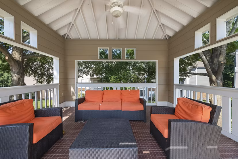 Outdoor patio area at Concord Apartments featuring modern seating and lush greenery for relaxing atmosphere